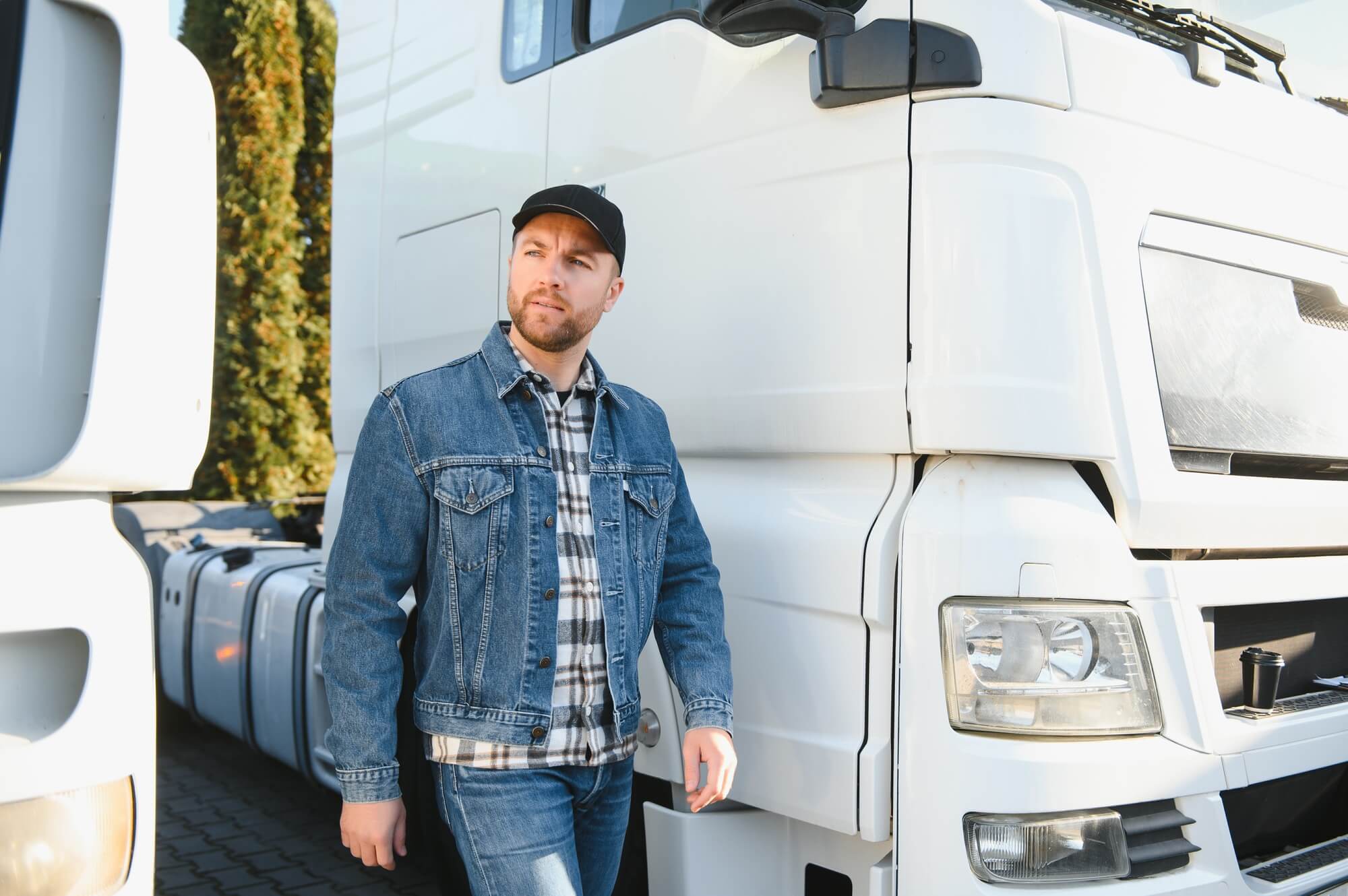 Men driver near lorry truck. Man owner truck driver near truck. Man trucker trucking owner.